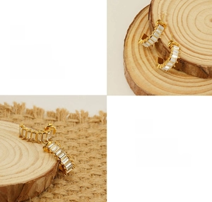 Polished gold U-shaped earrings featuring baguette-cut zircon stones and sleek plating