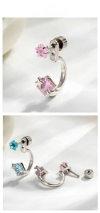 Detailed view of C-shaped star stud earrings with pink and blue square cubic zirconia stones