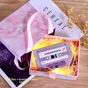 Pink marble gift box set with cassette card, raffia filler, and LED string lights