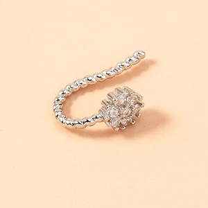 Detailed macro view of silver twisted metal earring with clear sparkling gemstones