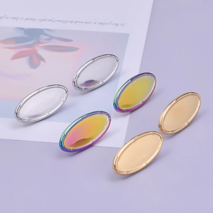 Detailed macro view of heart-shaped oval earring studs in silver, gold, and rainbow finishes