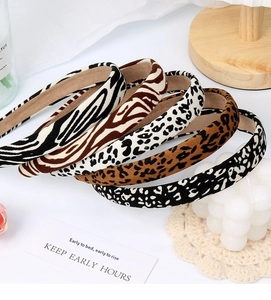 Detail of assorted animal print sponge headbands including leopard and zebra fabric patterns