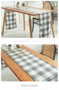 Detail of minimalist black and white checkered table runner with fine velvet texture