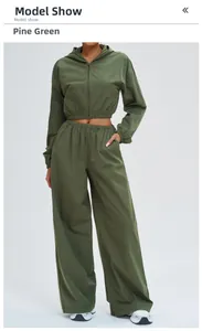 Detail of pine green two-piece sun protection set with zip hoodie and wide-leg sports pants