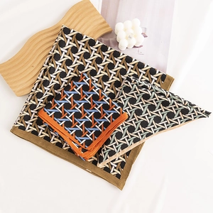 Korean retro houndstooth silk scarves on wooden decor with a candle, stylish accessories