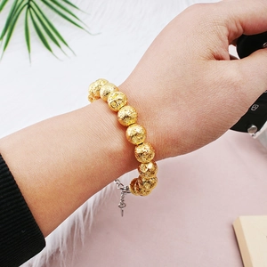 Textured gold beaded bracelet with lava stone pattern and extension chain for women