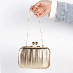 Metallic gold pleated evening clutch bag with vertical texture and metal chain strap