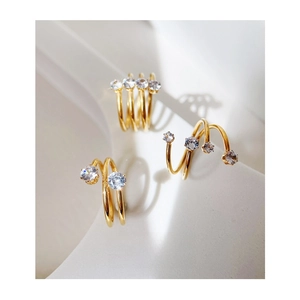 Close-up of triple-layered 18k gold plated spiral rings with sparkling zircon stones