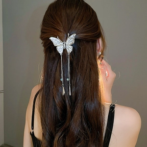 Rear view of elegant butterfly hair claw with sparkling rhinestones and long tassels