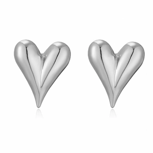 Macro shot of silver heart stud earrings with a smooth metallic polished finish