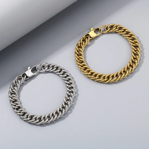 Detailed view of silver and gold titanium steel curb chains with lobster clasps