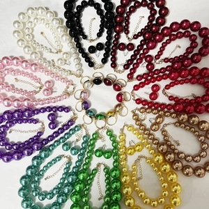 Top view of elegant pearl jewelry sets including necklace, earrings and rings in various colors