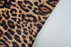 Detailed view of leopard print mesh fabric with high-quality stitching and texture