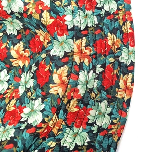 Macro detail of floral bucket hat fabric with multi-color print and reinforced stitching