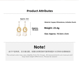 Detail view of gold mesh drop earrings with white rhinestones and teardrop pearls