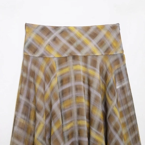Elegant plaid midi skirt in brown, yellow and grey grid pattern on a clean background