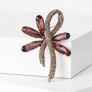 Elegant gold dragonfly brooch with purple crystals and sparkling rhinestone wings