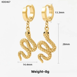Macro detail of gold plated stainless steel snake pendant earring with scale texture