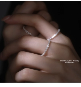 Close-up of sparkling S925 sterling silver bands on finger with skin-friendly texture