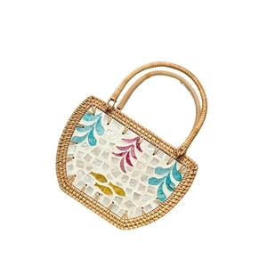 Handmade woven rattan shell bag with mosaic pattern and curved handle for beach vacations