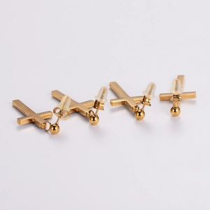 Golden stainless steel cross stud earrings set with crystal accents and plastic backings