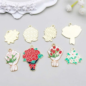 Detailed macro of white oil-dripped flower charms showing golden alloy backs and petals