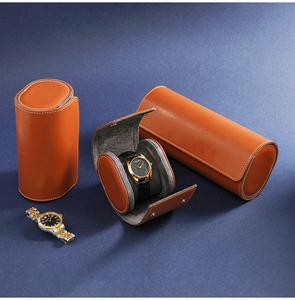 Detail view of orange leather watch roll case showing closed and open storage compartments