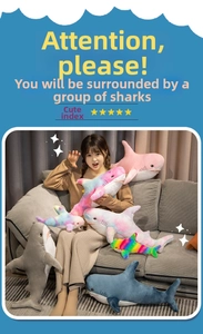 Various sizes of colorful plush shark dolls shown in a cozy home sofa setting