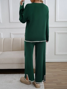 Detailed back view of dark green knit lounge set featuring white contrast piping and side slits