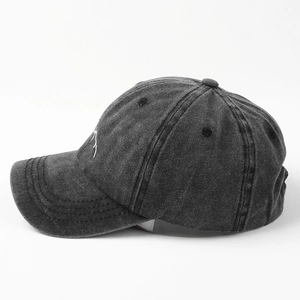 Macro shot of mountain embroidery on dark grey washed cotton baseball cap texture