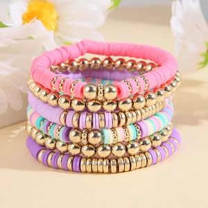 Detail of pink and purple polymer clay bead bracelets with gold metallic accents