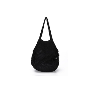 Detail shot of black woven mesh tote bag with durable braided texture and hollow design
