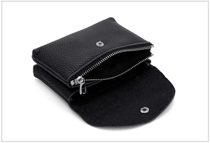 Detail of black genuine leather coin purse with silver zipper and snap closure pockets