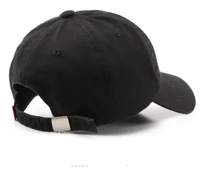 Macro detail of black cotton baseball cap back with adjustable strap and red tag