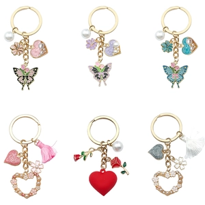 Zinc alloy keychains with butterfly and rose enamel charms, pearls and tassels on white