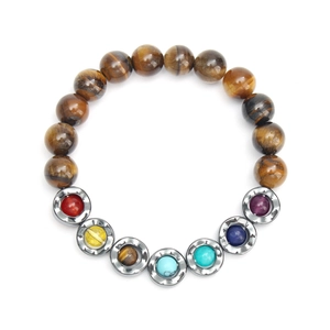 Detailed macro shot of yoga bead bracelet with tiger eye stones and colorful metal disks