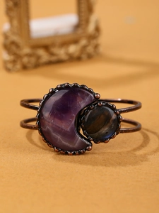 Detail view of vintage copper cuff bracelet with purple moonstone and round gem inlay