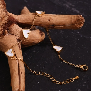 Detail showing 18K gold-plated chain with five white heart-shaped shell pendants