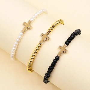 Three-piece stretch beaded bracelet set with faux pearls and golden cross charms