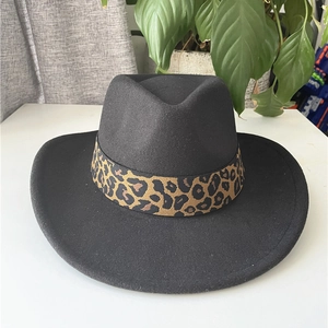Detail of classic black wool felt hat featuring a trendy leopard print decorative band