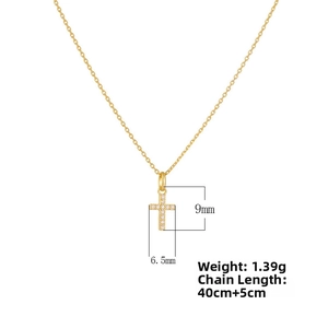 Detail showing cross pendant dimensions 9mm by 6.5mm on adjustable gold chain