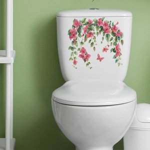 Watercolour pink flowers and butterfly wall sticker applied on a white toilet tank surface