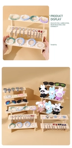 Detail view of multi-tier wooden display stand for jewelry and collectibles showcase