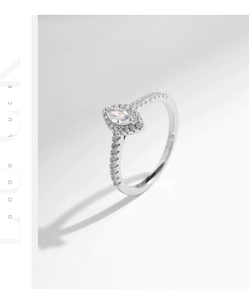 Macro shot of marquise-cut zircon engagement ring with silver pave setting on white background