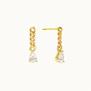 Detailed close-up of gold chain earrings featuring sparkling pear-cut cubic zirconia drops