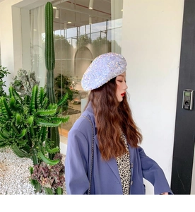 Detail of shimmering iridescent white sequins on a stylish beret hat for women
