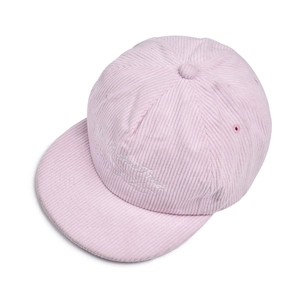 Close-up of pink corduroy baseball cap featuring white script embroidery and texture