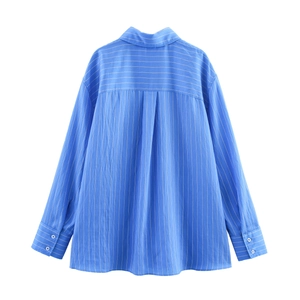 Back view of blue vertical striped long sleeve shirt with classic curved hem for women