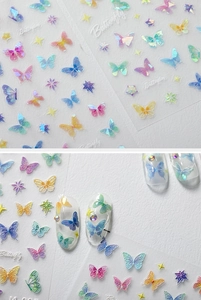Macro detail of 5D butterfly nail stickers showing colorful laser patterns and textures