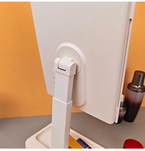 Detail of adjustable desktop LED makeup mirror stand with white folding base tray